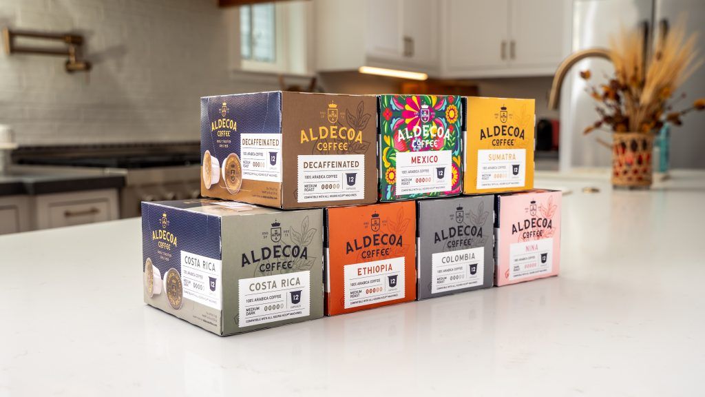 Aldecoa coffee product boxes stacked on a kitchen counter